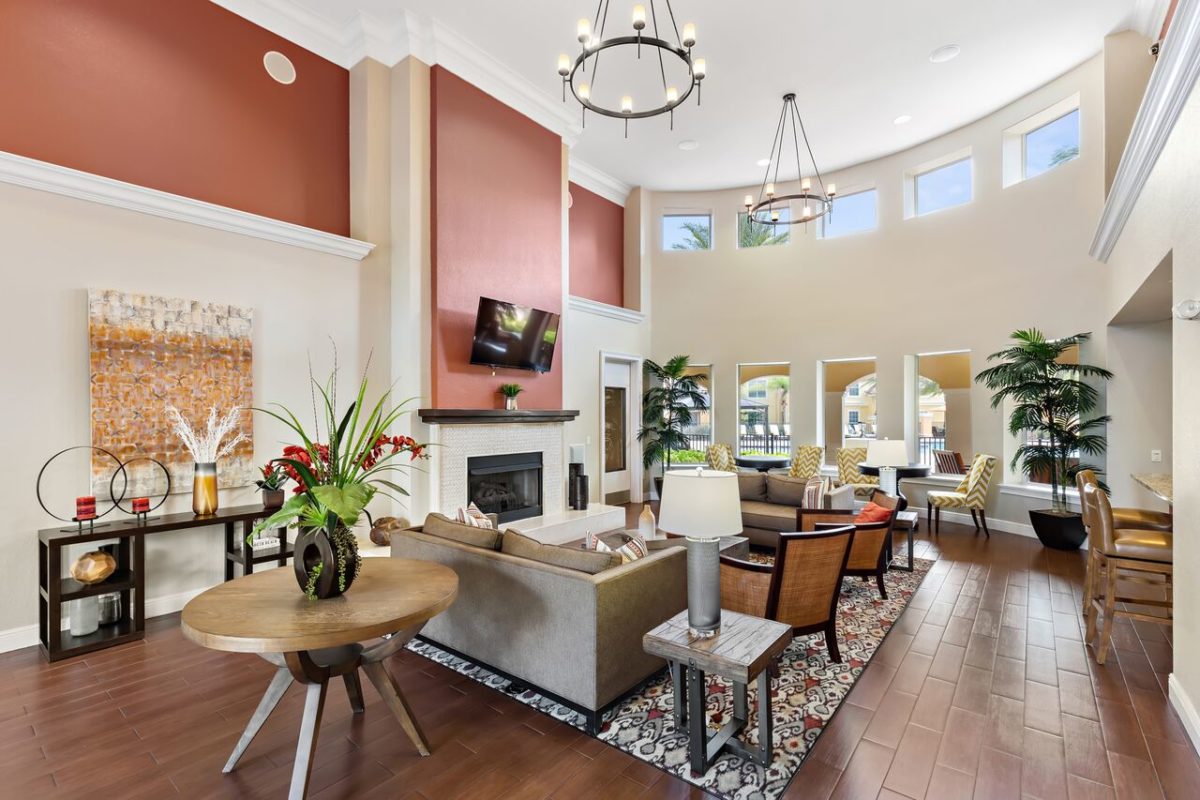 Club House featuring flat screen tvs, fireplace, seating, and hanging light fixtures