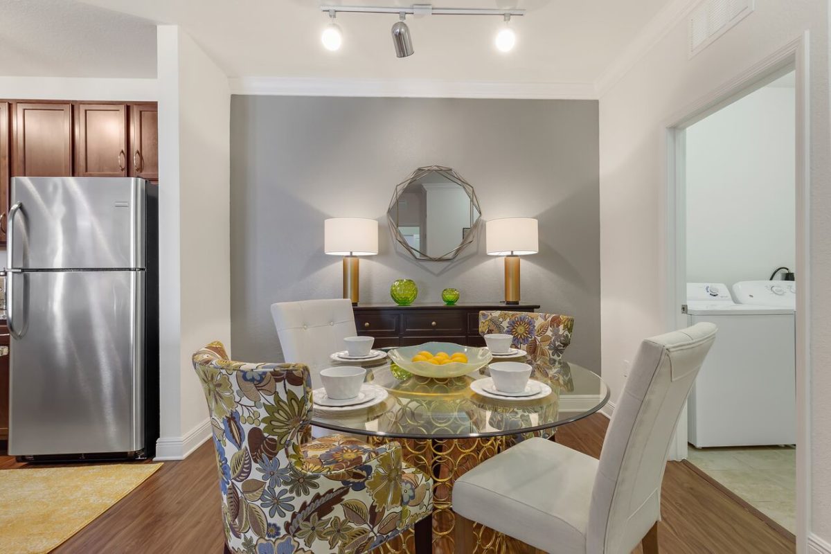 Luxury unit that features open concept kitchen and living area with island seating, dining area and mirror