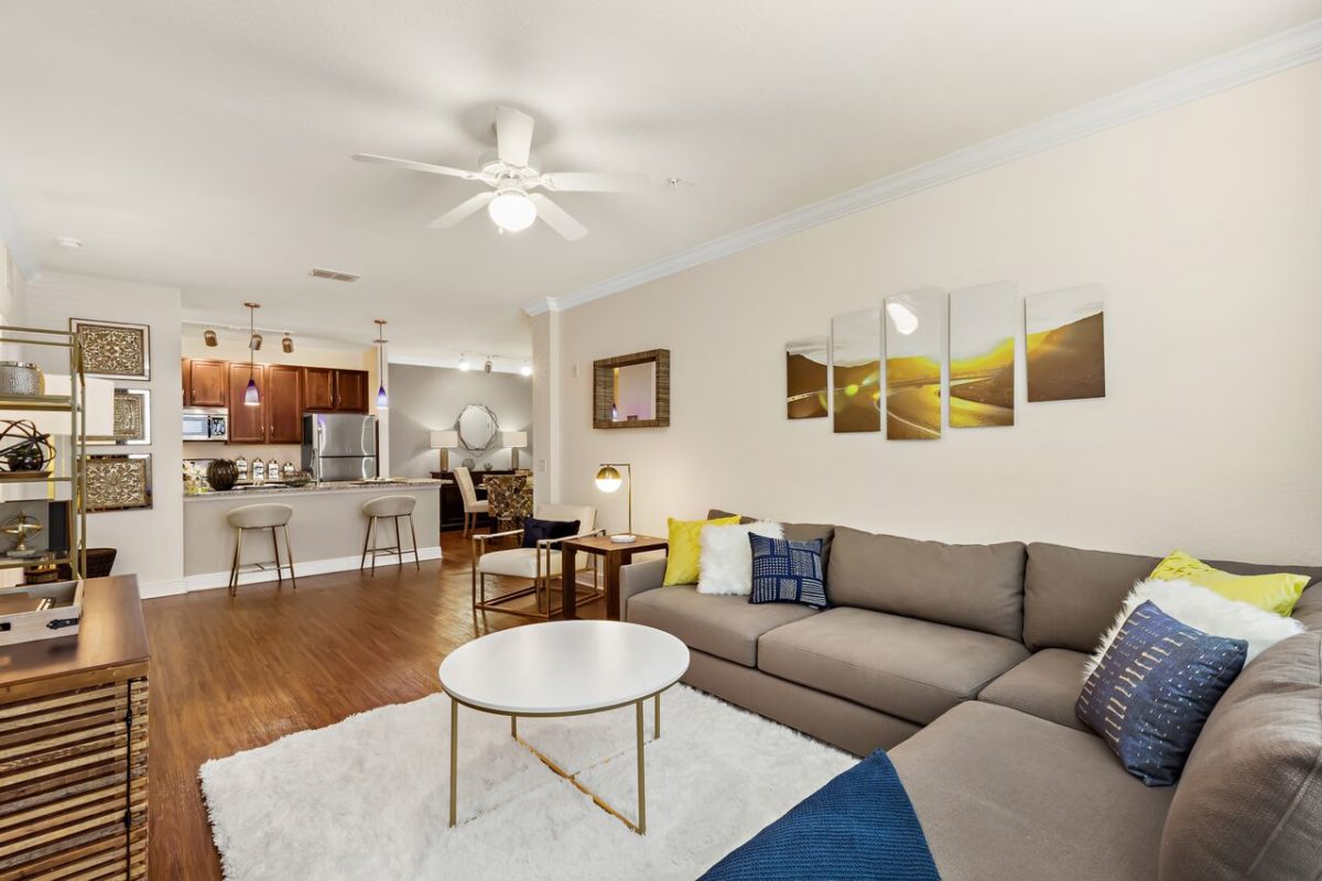 Furnished living room with kitchen reach-through into kitchen