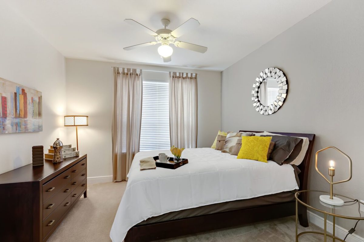 Bedroom with curtains bathroom and access to living room